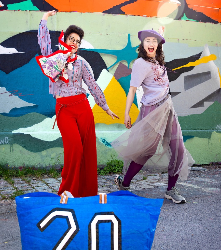 Wearing wonderful swapped clothes in front of a graffiti wall.