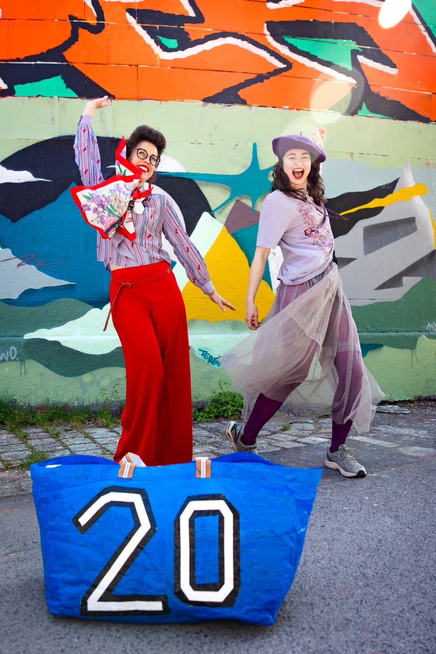 Wearing wonderful swapped clothes in front of a graffiti wall.