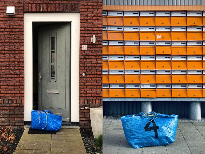 A numbered bag in front of a door and another in front of some letterboxes